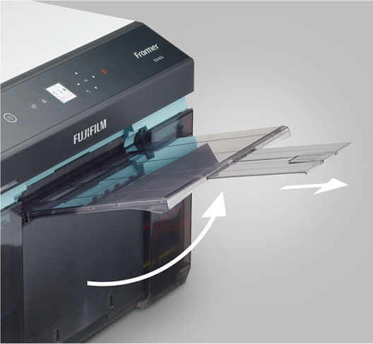 The output tray is integrated with the scrap paper box.