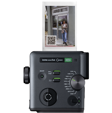 instax mini Evo™ printing instax photos™ with a QR code.