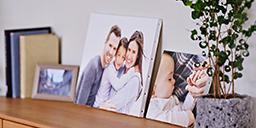 [photo] A framed picture and WALL DECOR canvas pannels are displayed on the shelf