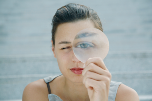 A woman looking through the glass lens