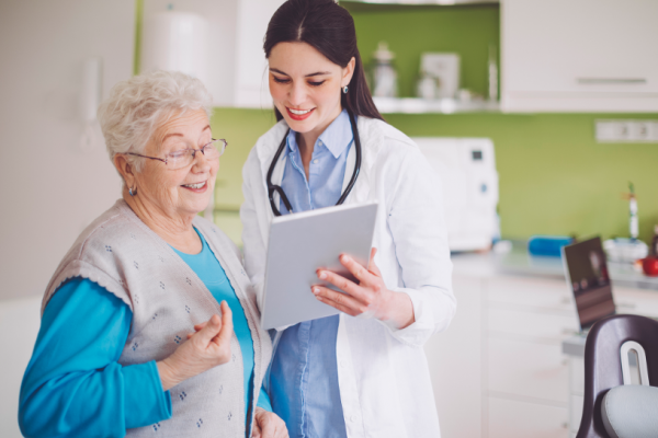 A doctor and a patient talking while looking at a tablet