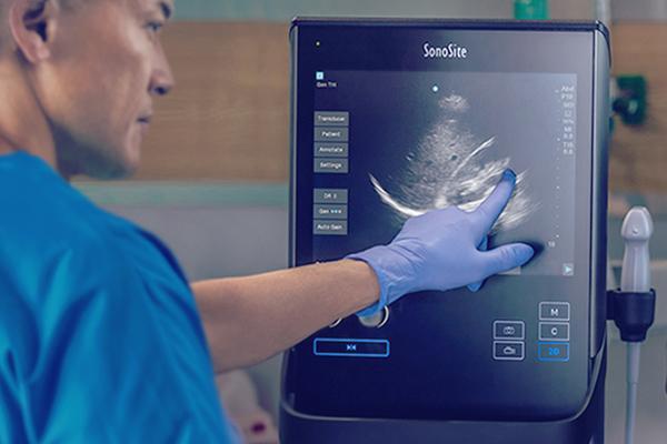 A doctors checking results through a monitor