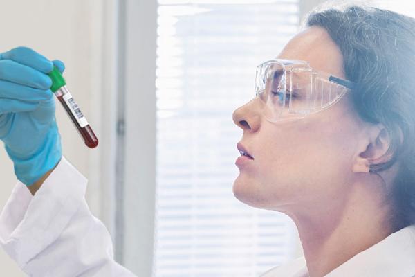 A woman checking a test tube